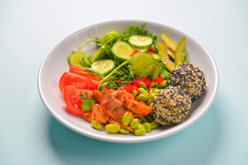 Fresh and organic vegetable salad with raw veggies - tomatoes, cucumbers, avocado. Flat lay, copy space banner.