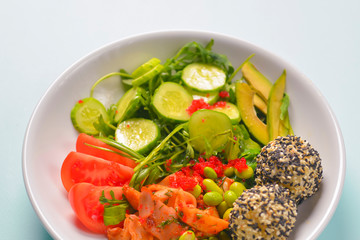 Fresh and organic vegetable salad with raw veggies - tomatoes, cucumbers, avocado. Flat lay, copy space banner.