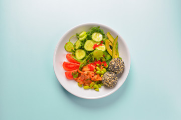 Fresh and organic vegetable salad with raw veggies - tomatoes, cucumbers, avocado. Flat lay, copy space banner.