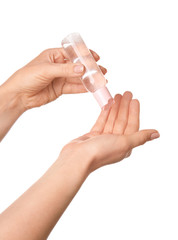 Woman using sanitizer on white background