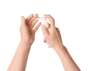 Woman using sanitizer on white background