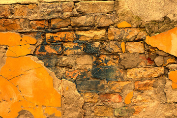 Orange texture old cracked brickwork house wall.