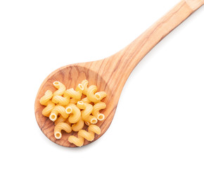 Spoon with uncooked pasta on white background