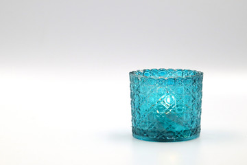  candle in vintage glass blue color on white background.