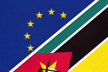 European Union or EU and Mozambique national flag from textile. Symbol of the Council of Europe association.