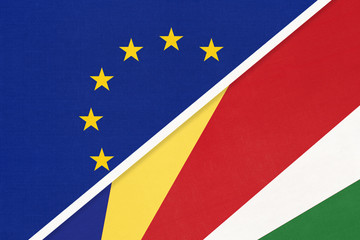 European Union or EU and Seychelles national flag from textile. Symbol of the Council of Europe association.