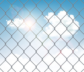 Fototapeta premium Fence made of metal wire mesh with a blue sky