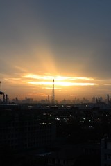 Naklejka premium A communications tower in Bangkok with the last sunshine of the day. A communications tower for television and mobile phone signals.