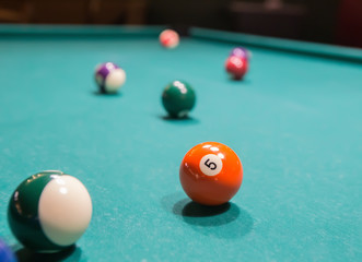 Colored billiard balls on a pool table.