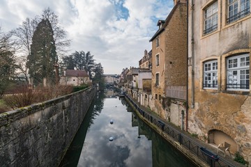 Ancient French classic medieval town with river in front, travel in a cloudy day