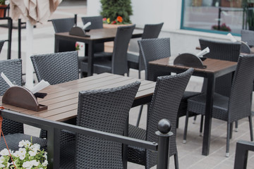 Sidewalk cafe without people on the street in the city