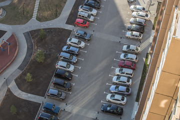 Cars parked in the courtyard of a residential apartment building.