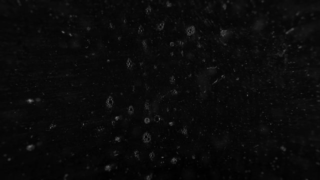 liquid detergent hitting the front glass lens of a camera, concept video to show sneezing bacteria flying around or prevent droplet infection or contagion during the coronavirus pandemic.