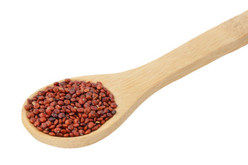 red quinoa seeds in wooden spoon isolated on white background with clipping path and full depth of field