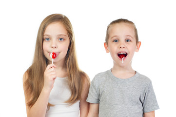 Young smiling caucasian girl and boy with lollipops isolated on white background - 353064330