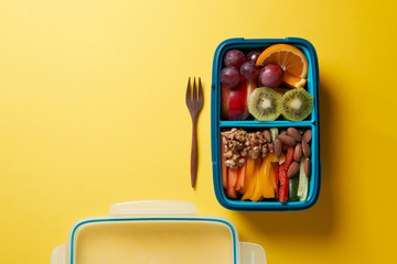 Top View of Full Lunch Box with Fuits, Vegetables and nuts.