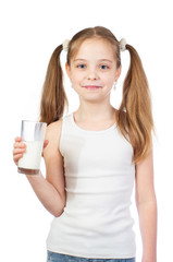 Young cute smiling girl with two hair tails and milky moustache holds a glass of milk isolated on white background - 353064568