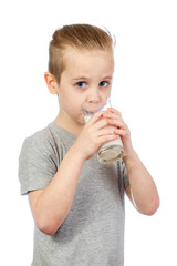 Young caucasian boy drinks milk up isolated on white background - 353064577