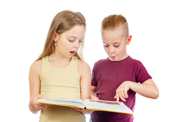 Young surprised cute girl and boy are looking at the yellow book isolated on white background - 353064770