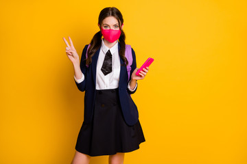 Portrait of high school student girl use smartphone make selfie wear backpack black blazer jacket skirt respiratory mask isolated over yellow color background