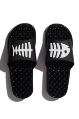 Detailed shot of black massage sandals with knobby balls on the soles and with white fishbone print on straps. The pair of footwear for foot pain treatment is located on the white background.