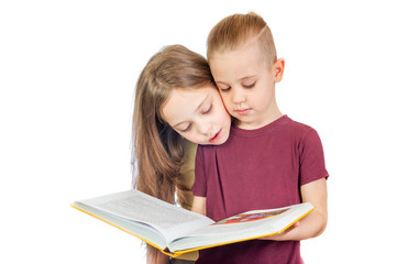 Young cute girl and boy are looking at the yellow book isolated on white background - 353064797