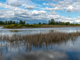 calm scene of beautiful sky with cumulus clouds reflection on the lake
