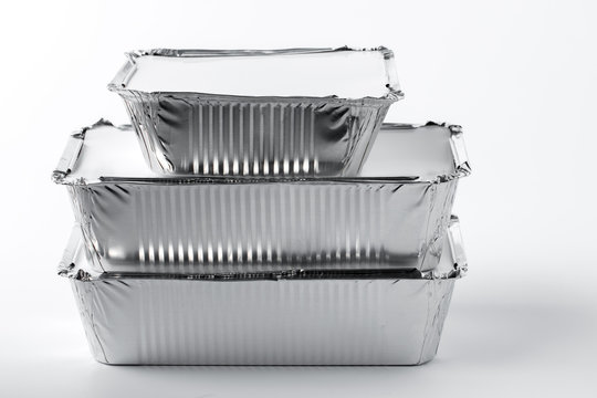Takeaway meal in foil food box on white background