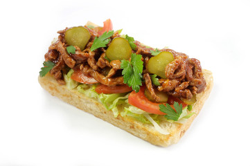 grilled toast with meat in sauce, parsley, green salad and pickled cucumber isolated on white background