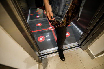 Details with an elevator floor segmented in four places to stand for social distancing during the...