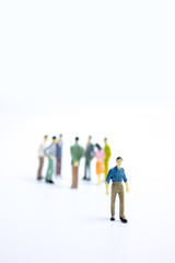 miniature businessmen keep distance away in the meeting with distant measure. Social distancing concept avoid COVID-19 coronavirus spreading.