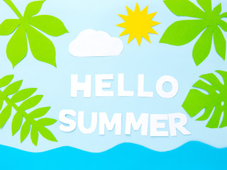 Fototapeta na wymiar A words HELLO SUMMER of paper cut letters on a blue summer background