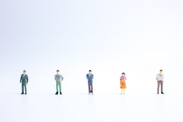miniature businessmen keep distance away in the public. Social distancing concept avoid COVID-19 coronavirus spreading.