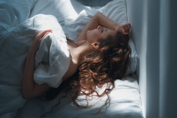 Stock photo -  Girl under the covers in her bed