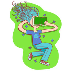 girl in blue is lying on the grass reading a book