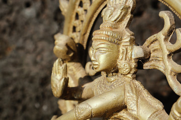 Fototapeta premium Bronze dancing god Sivan against dark background.
