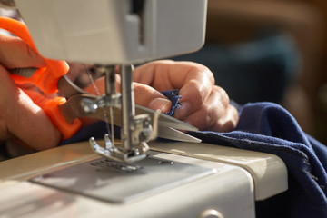 Tailoring Process - Women's hands behind her sewing