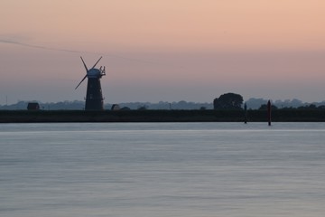 Sunset over Norfolk Broads windmill in Burgh Castle, Great Yarmouth, England, UK.