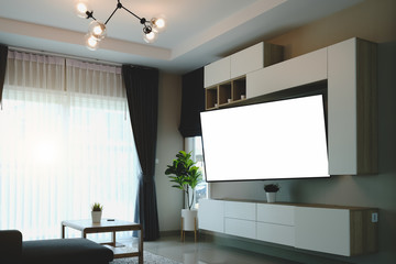 Wide blank screen TV on white stand near light wall in living room.