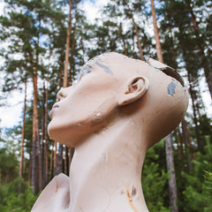 Old abandoned broken sad mannequin. Post-apocalyptic future. Old abandoned building. Hopelessness and despondency, forgetfulness. Vintage photo.