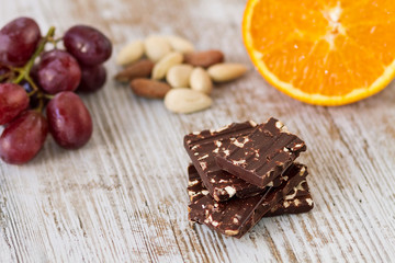 Obraz na płótnie Canvas Dark chocolate with almonds and fruits