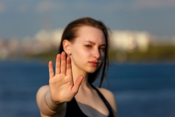 Fototapeta na wymiar Girl teenager's palm is put forward closeup with blurred summer background