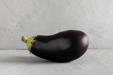 Fresh eggplant on grey concrete background with copy space.  © alexburakov12