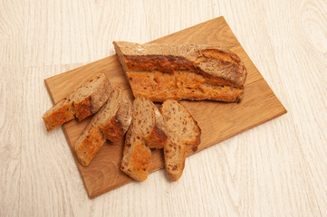 French buckwheat loafs sliced into pieces on a wooden board