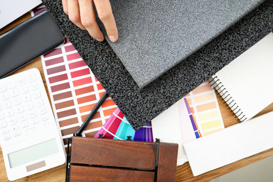 Male desinger hand hold rubber mat top view background