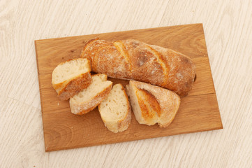 French loafs sliced into pieces on a wooden board
