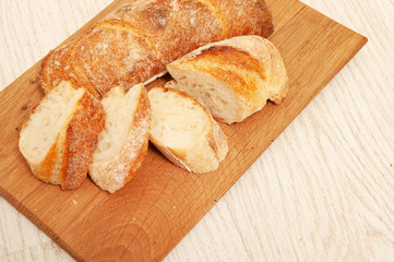 French loafs sliced into pieces on a wooden board