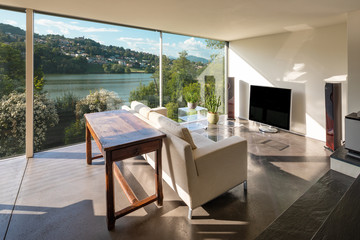 Modern lounge with a beautiful view of a pond. We are in Switzerland