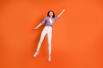 Full body photo of amazed excited girl jump hold hand want catch umbrella fly in sky feel crazy...
