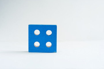 wooden cube with round holes in blue color